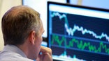 Britain's fraud prosecutor charged a former trader with conspiracy to defraud, as part of a probe the manipulation of benchmark interest rates.